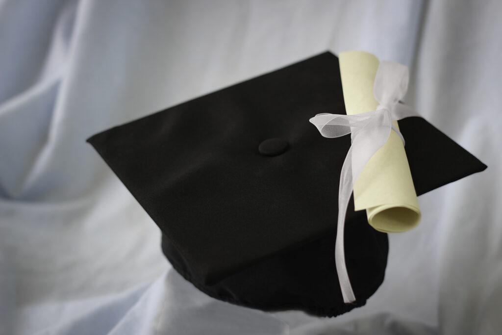 A graduation mortarboard and scroll