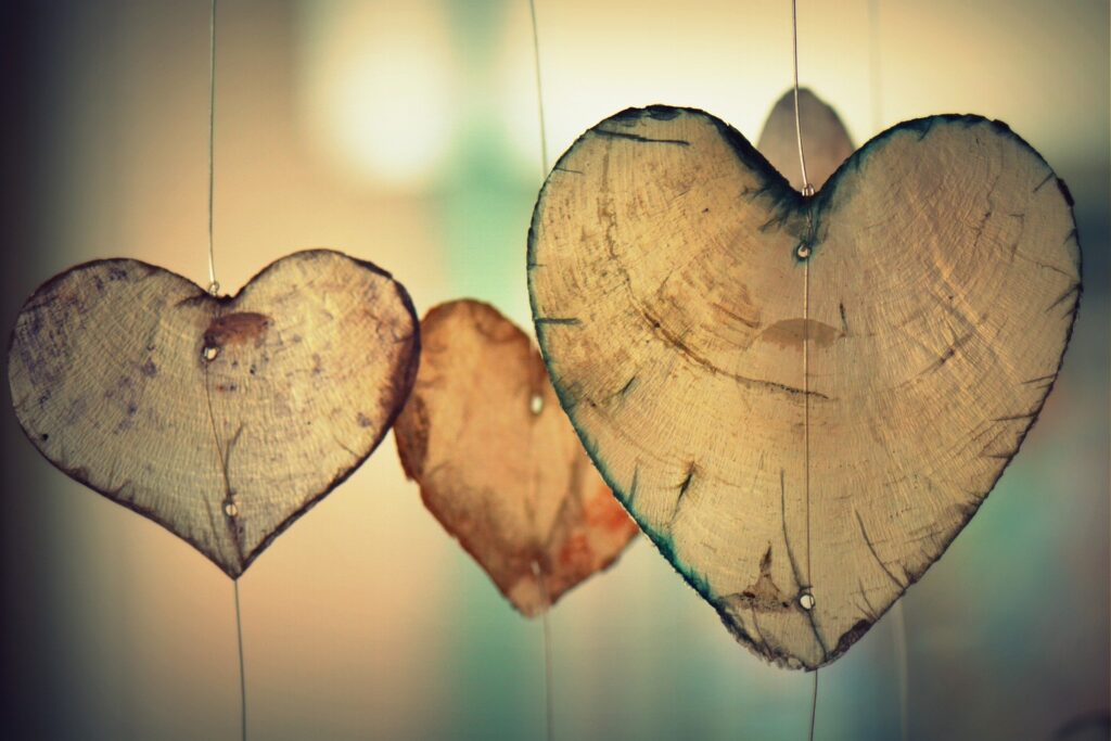 Stock image of 4 wooden hearts hung up from wire