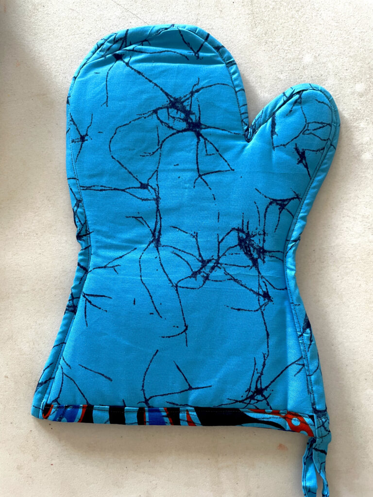 turquoise glove with black design