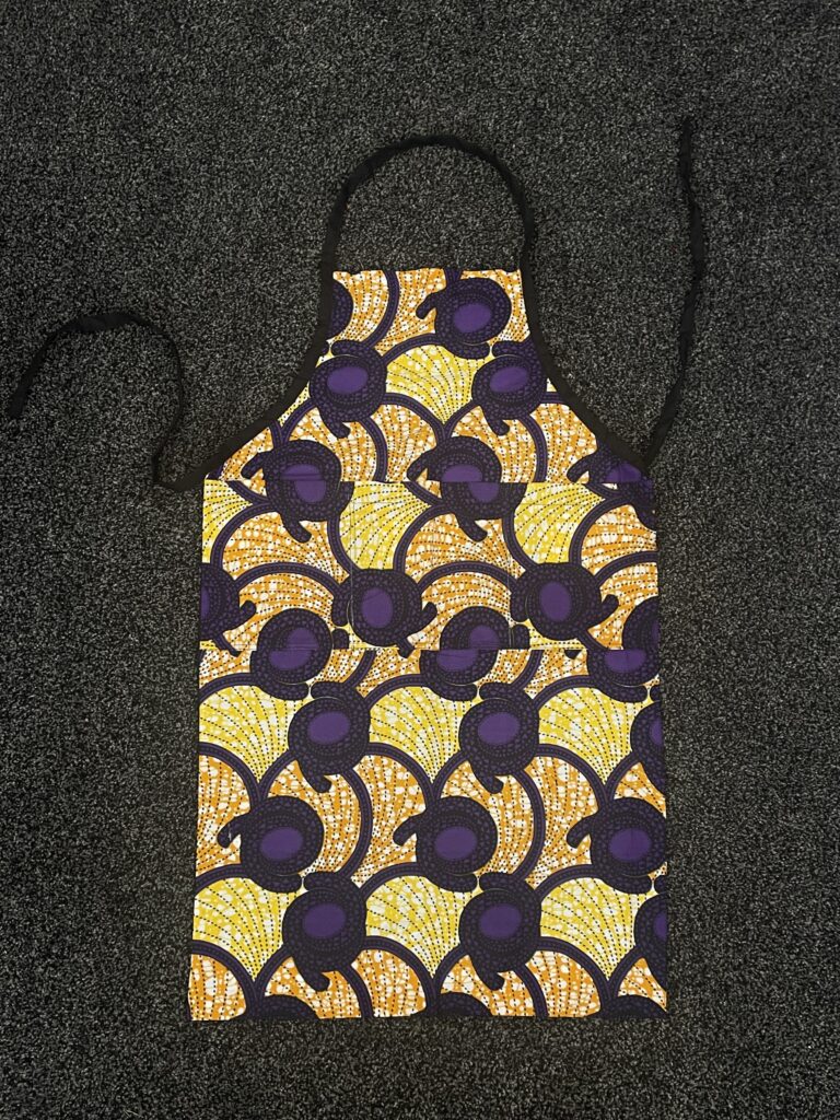 kitchen apron with purple, yellow and orange pattern