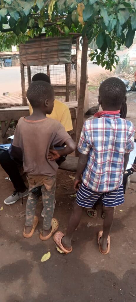 two young boys standing together, facing away from the camera