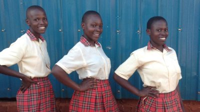 three girls posing for the camera in school uniform