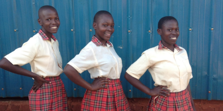 three girls posing for the camera in school uniform