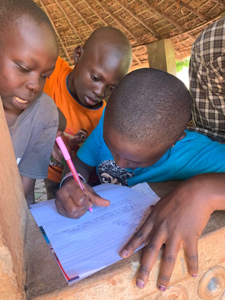 a group of children with one writing