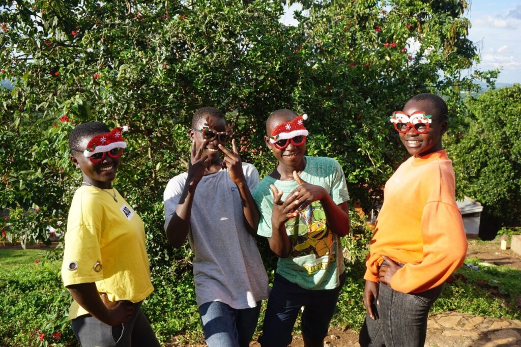 Four children wearing christmas sunglasses